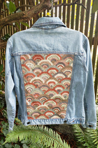 upcycled denim jacket with geometric upholstery patch on back